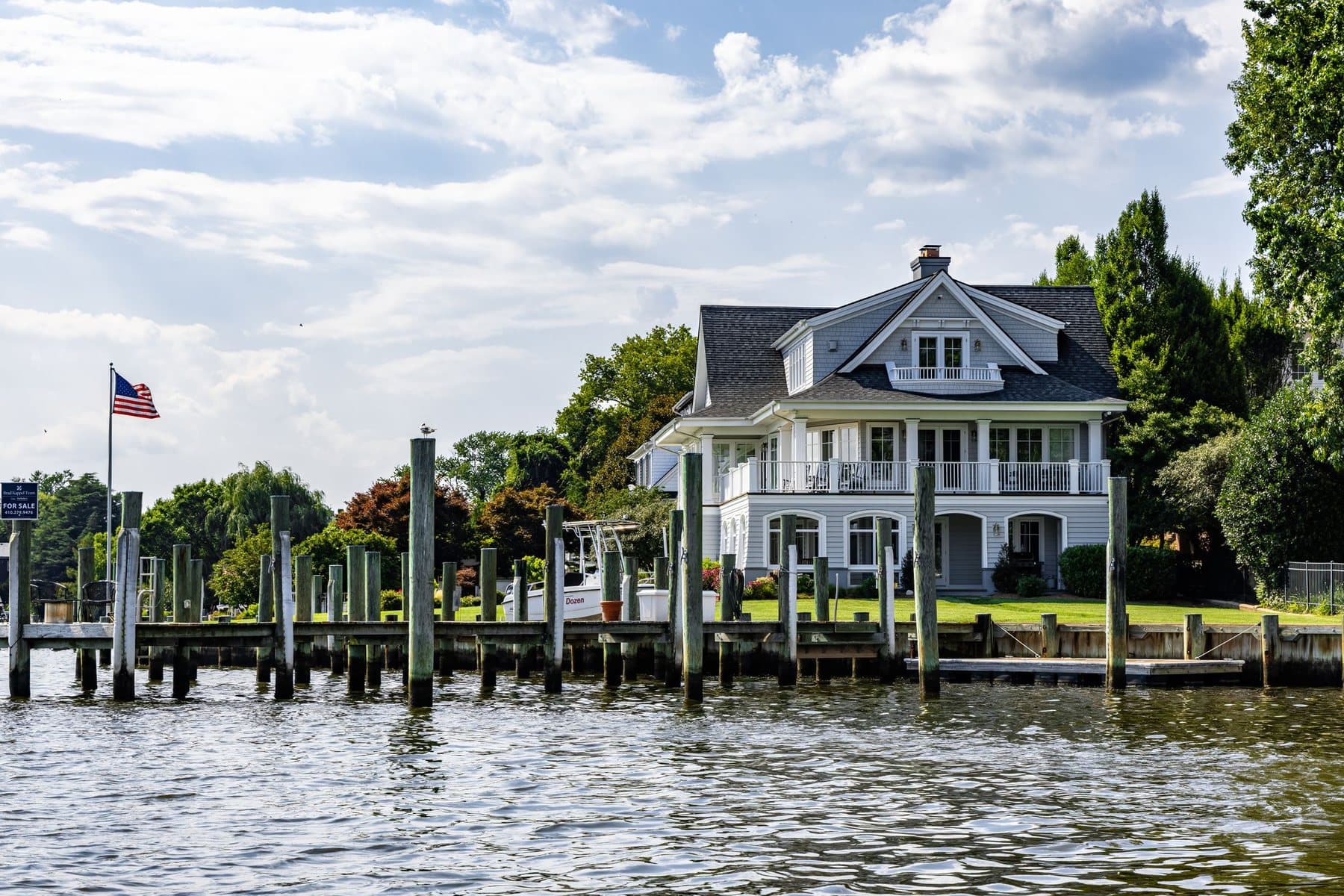 American waterfront home with a private dock and flag