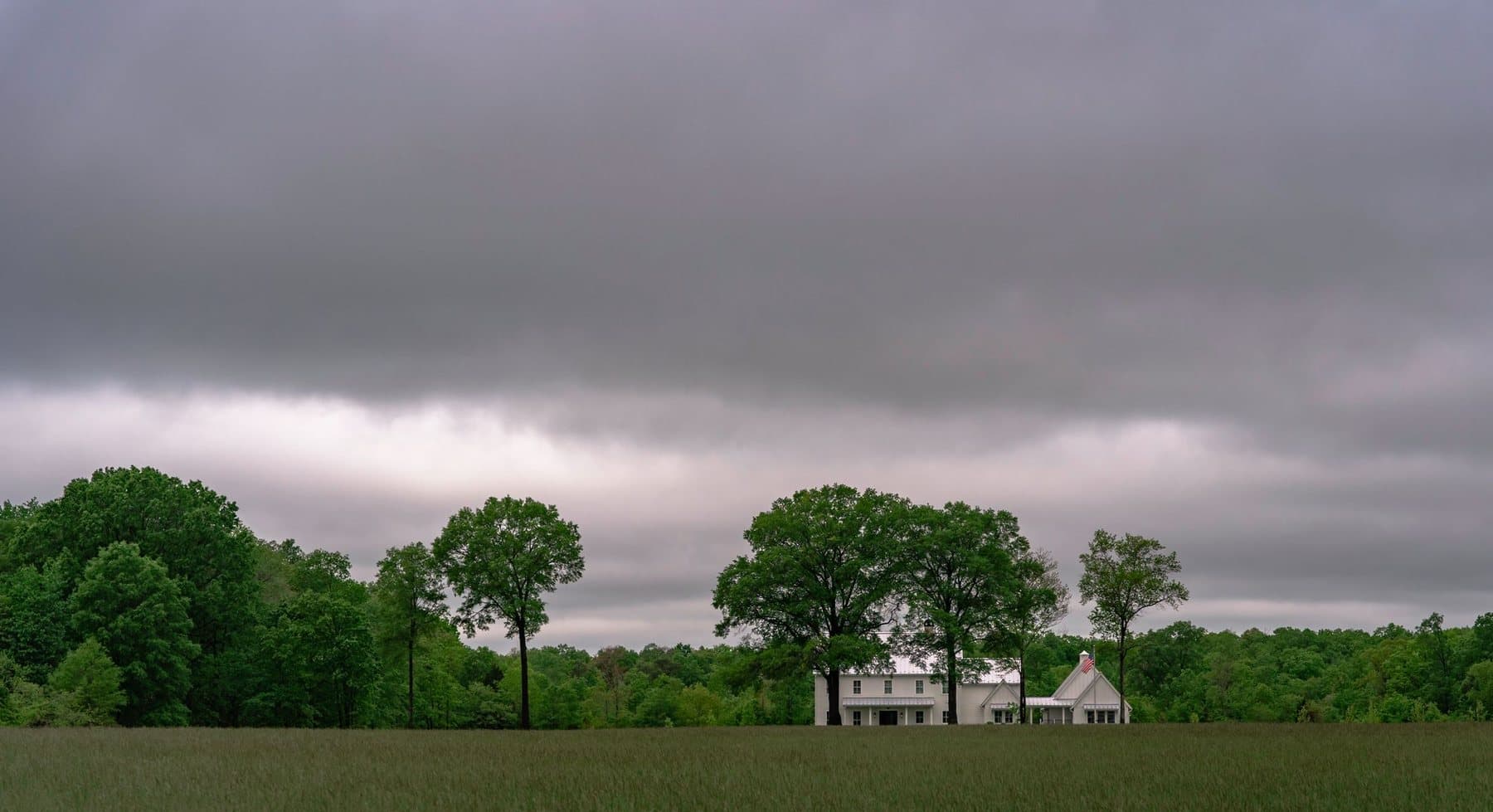 Rural Virginia farmhouse under storm clouds