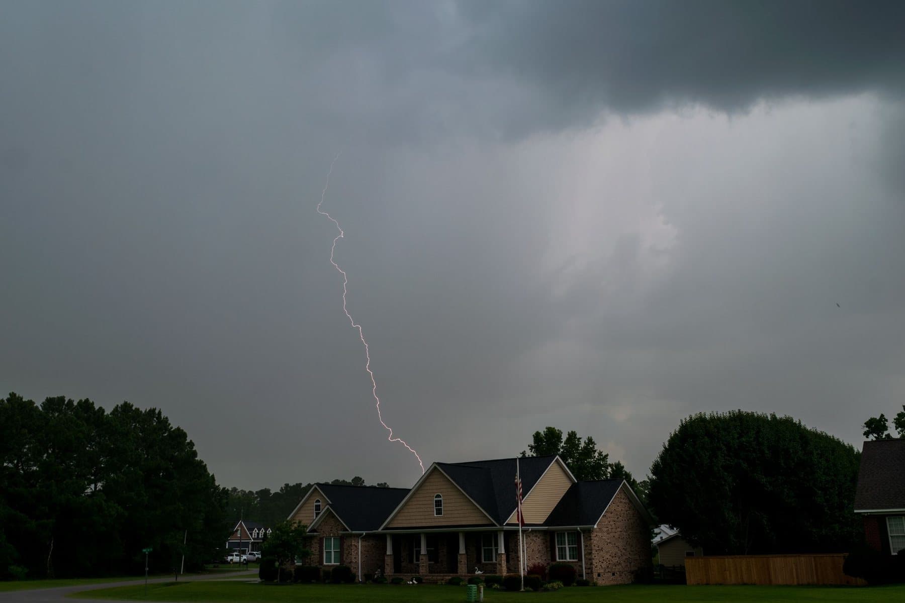 Lightning flashing over homes during a North Carolina storm